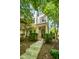 Charming townhouse with a welcoming porch, surrounded by mature trees and well-maintained landscaping at 1427 Van Page Blvd, Raleigh, NC 27607