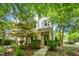 Charming townhouse with a covered porch, surrounded by lush greenery and mature trees at 1427 Van Page Blvd, Raleigh, NC 27607