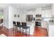 Modern kitchen with island seating, stainless steel appliances, and granite countertops at 1427 Van Page Blvd, Raleigh, NC 27607