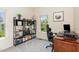 Bedroom space with a modern workstation and a large window with wooded backyard views at 1427 Van Page Blvd, Raleigh, NC 27607