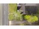 Aerial view showcases the roof, lawn, and tree coverage of the property at 1512 Oxford Rd, Henderson, NC 27536