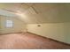 A spare room in the attic with plank floors, ceiling, and one window at 1512 Oxford Rd, Henderson, NC 27536