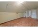 An attic spare room with paneled ceilings and walls, plank floors, and a doorway at 1512 Oxford Rd, Henderson, NC 27536