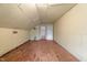 An attic with paneled walls, plank floor, and doorway at 1512 Oxford Rd, Henderson, NC 27536