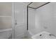 View of a bathroom with the shower over tub with black and white tile at 1512 Oxford Rd, Henderson, NC 27536