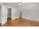A spare bedroom with wood floors, angles, and a door leading to the hallway at 1512 Oxford Rd, Henderson, NC 27536