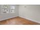 This bedroom features hardwood floors and natural light from the windows at 1512 Oxford Rd, Henderson, NC 27536