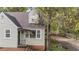 Charming home featuring a blend of siding, brick foundation, and a welcoming black front door at 1512 Oxford Rd, Henderson, NC 27536