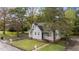 Attractive exterior of a charming home with green lawn and mature trees adding to its appeal at 1512 Oxford Rd, Henderson, NC 27536