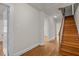 View of hallway and wooden stairs leading to the upper level of the home at 1512 Oxford Rd, Henderson, NC 27536