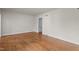 An empty living room with hardwood floor and a white wall, ready to be filled with furniture at 1512 Oxford Rd, Henderson, NC 27536