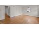 Spacious living area with hardwood floors, bright walls, and natural light from the window at 1512 Oxford Rd, Henderson, NC 27536