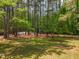 View of the yard with mature trees at 1608 New Hill Olive Chapel Rd, Apex, NC 27502