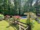 View of a backyard pool with a weathered direction sign in the foreground at 1608 New Hill Olive Chapel Rd, Apex, NC 27502