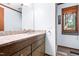 Bathroom features granite countertops, dark wood vanity, and natural light from the window at 1608 New Hill Olive Chapel Rd, Apex, NC 27502