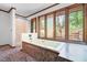 Bright bathroom featuring a soaking tub and large windows offering relaxing views of nature at 1608 New Hill Olive Chapel Rd, Apex, NC 27502