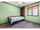 A bedroom showcases wood trim, a ceiling fan, blinds on the window, and built-in shelving at 1608 New Hill Olive Chapel Rd, Apex, NC 27502