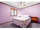 Cozy bedroom with plush carpet, a decorative bedspread, and natural light creating a peaceful retreat at 1608 New Hill Olive Chapel Rd, Apex, NC 27502