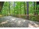 Spacious wooden deck overlooking a lush, wooded backyard at 1608 New Hill Olive Chapel Rd, Apex, NC 27502