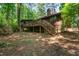 Exterior of the home with wooden deck and stairs leading down to the yard at 1608 New Hill Olive Chapel Rd, Apex, NC 27502
