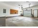 Spacious garage with overhead door, pegboard, and concrete flooring, providing ample storage and workspace at 1608 New Hill Olive Chapel Rd, Apex, NC 27502