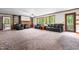 Large living room with plush carpet, wood trim, brick fireplace, and built-in bookcases for cozy living at 1608 New Hill Olive Chapel Rd, Apex, NC 27502