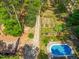Aerial view of an in-ground pool surrounded by a deck and mature trees at 1608 New Hill Olive Chapel Rd, Apex, NC 27502