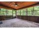 Cozy screened-in porch with wood paneling and views of the surrounding woods at 1608 New Hill Olive Chapel Rd, Apex, NC 27502