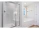 Modern bathroom featuring a shower, soaking tub, and window providing natural light at 162 Tuskeegee Dr, Smithfield, NC 27577