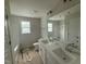 Bright bathroom featuring a double vanity with undermount sinks, large mirror, and a window for natural light at 162 Tuskeegee Dr, Smithfield, NC 27577