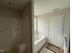 Bright bathroom features a bathtub, shower, and window, ready for finishing at 162 Tuskeegee Dr, Smithfield, NC 27577