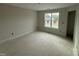 Bright bedroom featuring a large window with natural light and neutral walls at 162 Tuskeegee Dr, Smithfield, NC 27577