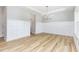 Bright dining room with wainscoting, contemporary chandelier, and hardwood floors at 162 Tuskeegee Dr, Smithfield, NC 27577