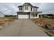 Two-story home features stone accents, white siding, a welcoming front porch, and a spacious driveway at 162 Tuskeegee Dr, Smithfield, NC 27577
