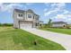 Two-story home with stone accents, attached two-car garage, and a long concrete driveway at 162 Tuskeegee Dr, Smithfield, NC 27577