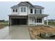 Two-story home with stone accents, a two-car garage, and a welcoming front porch at 162 Tuskeegee Dr, Smithfield, NC 27577