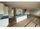 Open-concept kitchen features white cabinets, island, and seating, ready for finishing touches at 162 Tuskeegee Dr, Smithfield, NC 27577
