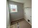A simple laundry room with laminate floors and a wire rack shelf at 162 Tuskeegee Dr, Smithfield, NC 27577