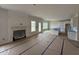 Open-concept kitchen and living room with fireplace, windows, and an island with bar seating at 162 Tuskeegee Dr, Smithfield, NC 27577