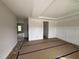 Bright living room with elegant wainscoting detail and a tray ceiling awaiting flooring at 162 Tuskeegee Dr, Smithfield, NC 27577