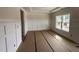 Sunlit living room showcasing wainscoting and a large window ready for flooring at 162 Tuskeegee Dr, Smithfield, NC 27577
