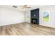 Bright living room featuring a ceiling fan, fireplace, and a large window at 162 Tuskeegee Dr, Smithfield, NC 27577