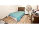 Cozy bedroom featuring wood floors, a bed with blue covers, and a window for natural light at 1620 Old Wilson Rd, Rocky Mount, NC 27801
