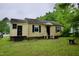 A charming single-story home with black shutters and a well-maintained lawn on an overcast day at 1620 Old Wilson Rd, Rocky Mount, NC 27801