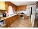 Functional kitchen with wood cabinets, stainless steel appliances, and vinyl floors at 1620 Old Wilson Rd, Rocky Mount, NC 27801