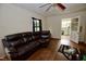 Spacious living room featuring hardwood floors, white walls, and a comfortable brown sectional sofa at 1620 Old Wilson Rd, Rocky Mount, NC 27801
