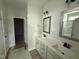 Bathroom featuring a double sink vanity, framed mirrors, and a glass-enclosed shower at 188 Tuskeegee Dr, Smithfield, NC 27577