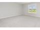 Bright bedroom featuring a large window, neutral carpet, and ample natural light at 188 Tuskeegee Dr, Smithfield, NC 27577