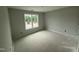 Well-lit bedroom with a large window offering views of the surrounding landscape at 188 Tuskeegee Dr, Smithfield, NC 27577