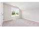 Upstairs bedroom with neutral carpet and an expansive window view at 188 Tuskeegee Dr, Smithfield, NC 27577